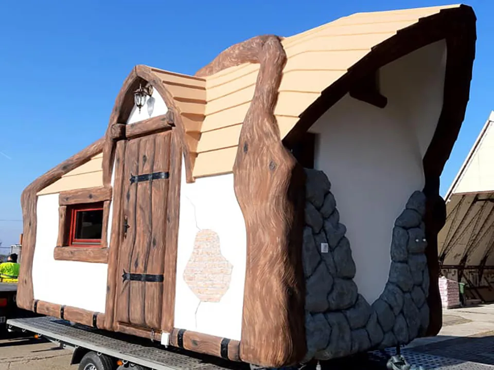 A finished fairy tale house travelling on a trailer