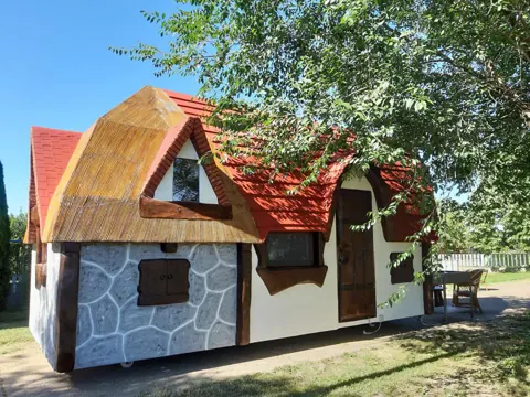 Storybook cottage with thatched-look roof and stone facade